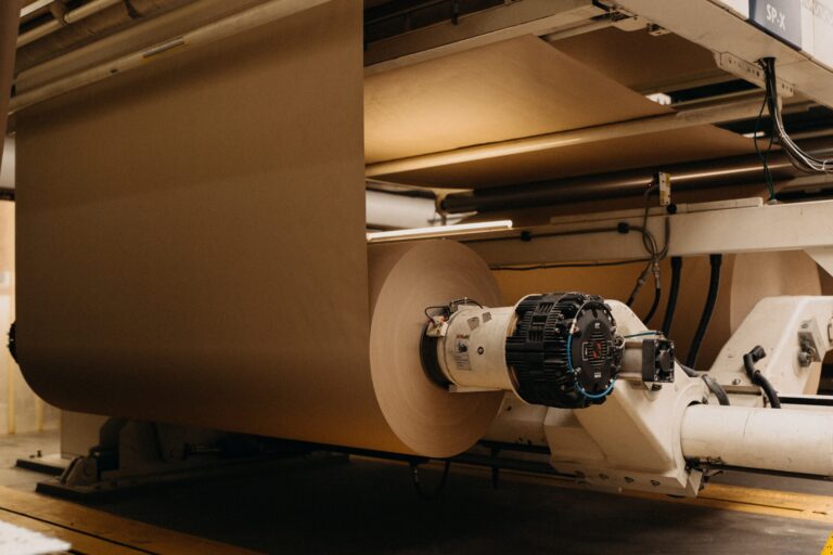 brown paper roll on a machine in a paper mill